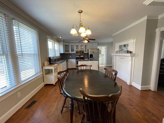 727 Lattimore Road Rutherfordton, NC 28139 - Photo 8 of 48 a dining room with wooden floor a chandelier a wooden table and chairs