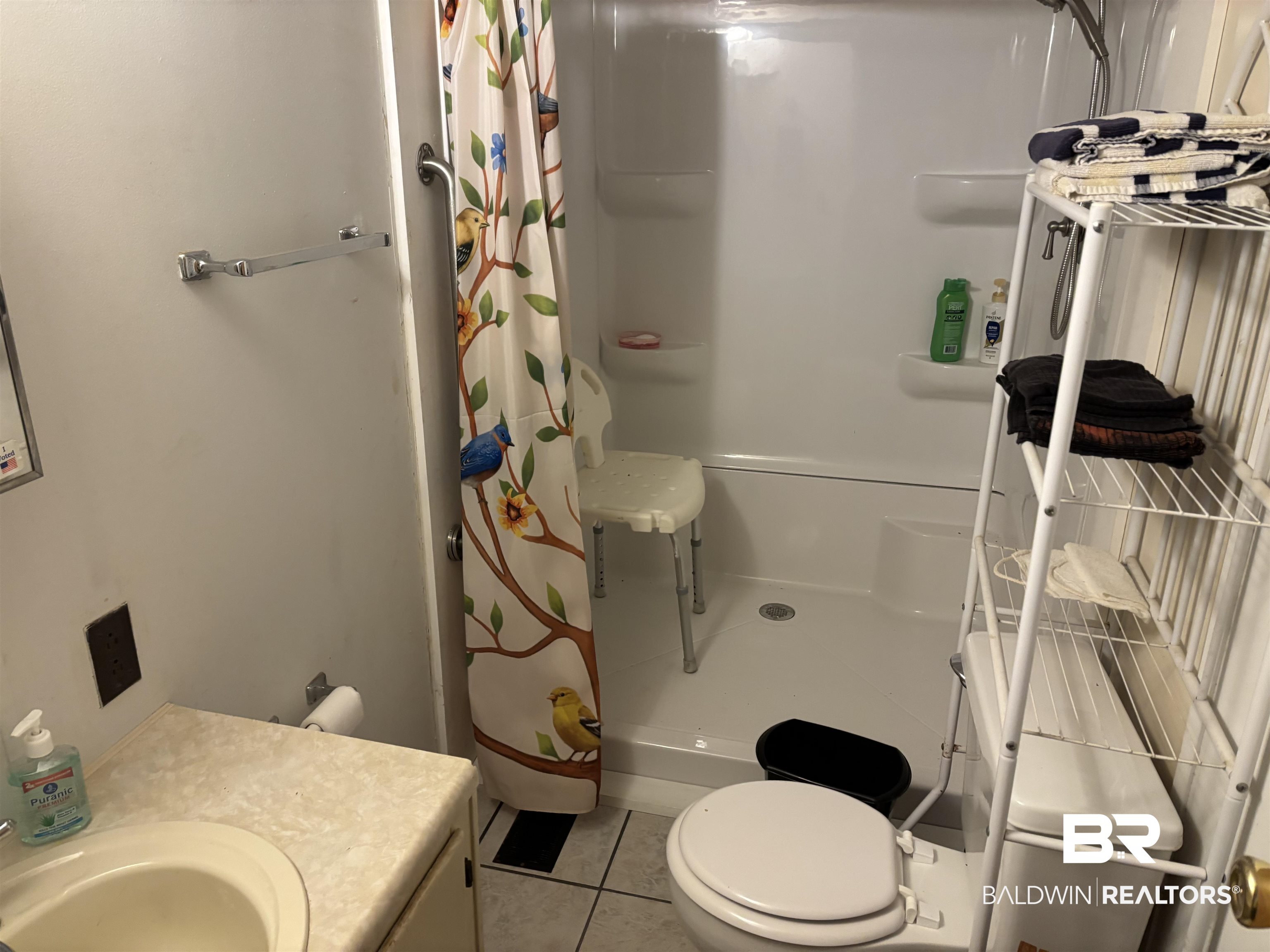 15575 Rogers Drive Chunchula, AL 36521 - Photo 34 of 42 Full bath featuring toilet, a stall shower, tile patterned flooring, and vanity