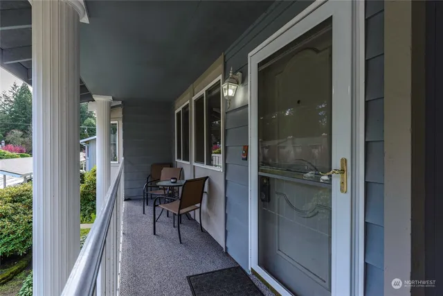 a balcony with chairs and table in a balcony