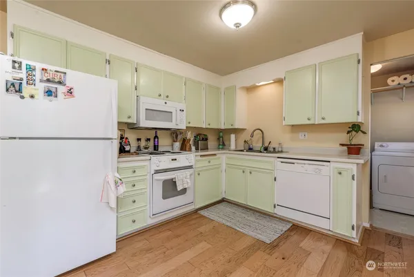 a kitchen with a white cabinets and white appliances