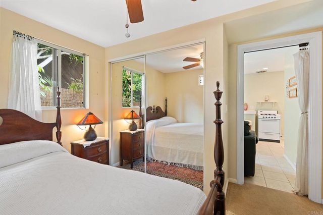 a bed room with two beds and a large window