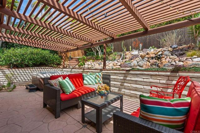 an outdoor sitting area with a table and chairs
