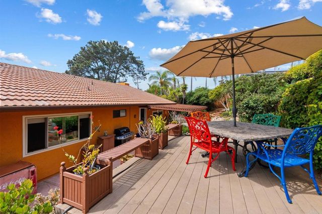 an outdoor space with furniture and umbrella