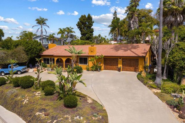 a front view of a house with sitting area