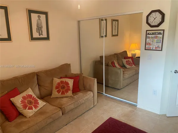 a living room with furniture and a wall painting