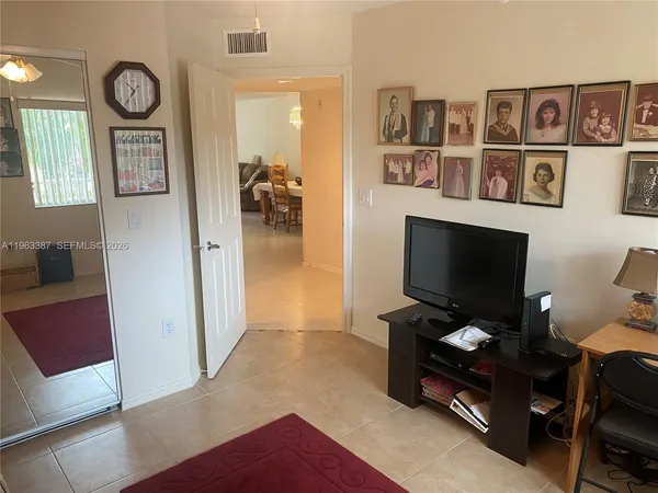 a view of a livingroom with furniture and a flat screen tv