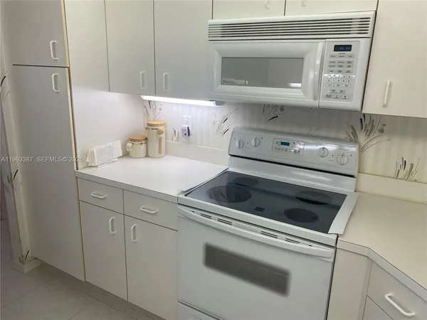 a kitchen with a stove and a microwave