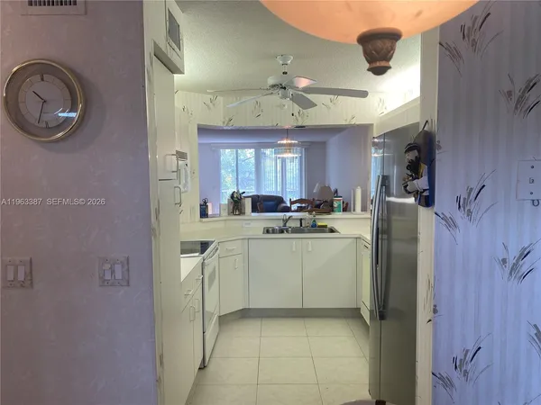 a kitchen with stainless steel appliances granite countertop a washer and dryer