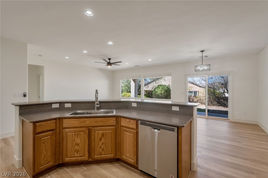 2535 Anani Road Henderson, NV 89044 - Photo 6 of 13 A well-appointed kitchen island with ample counter space overlooks a serene outdoor setting.