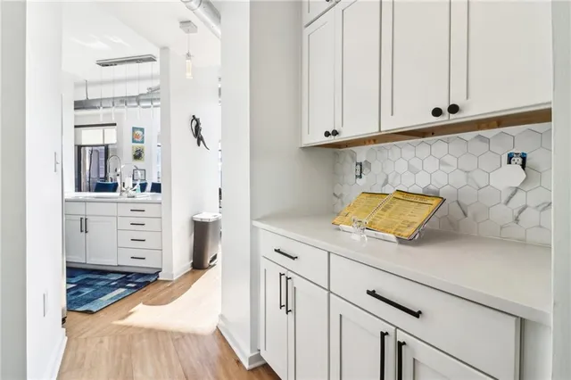 a kitchen with stainless steel appliances white cabinets and a refrigerator