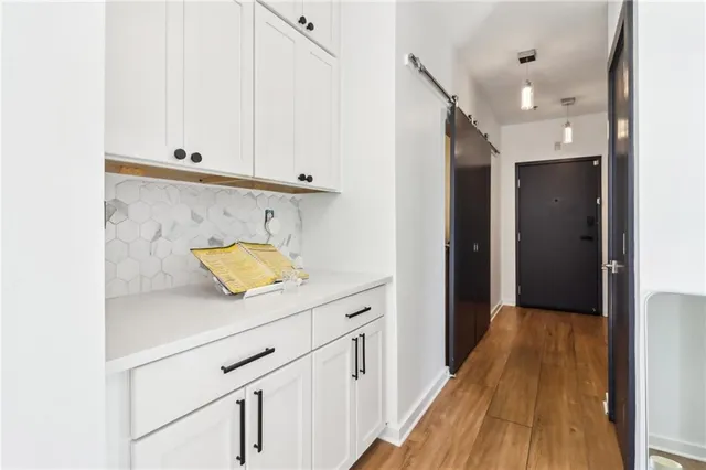 a view of hallway with wooden floor