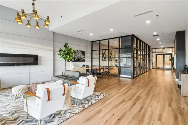 a living room with furniture wooden floor and a table