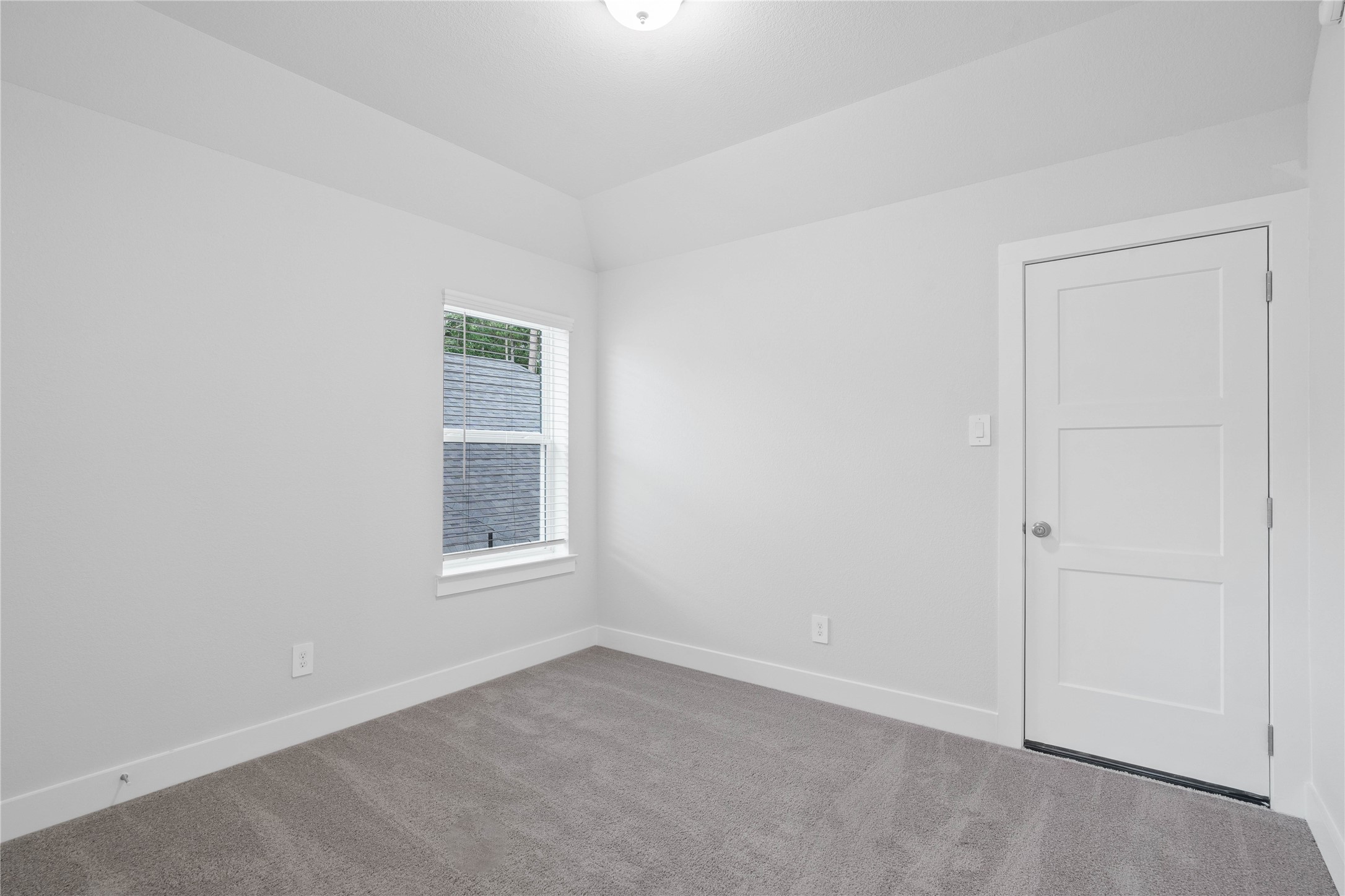2035 Frst Strm Way Conroe, TX 77304 - Photo 37 of 45 Step into this bright and airy secondary bedroom! It offers a tranquil space to unwind. The large window illuminates the room's sloped ceiling and neutral tones, creating a cheerful and airy environment. This room also features a spacious closet.
