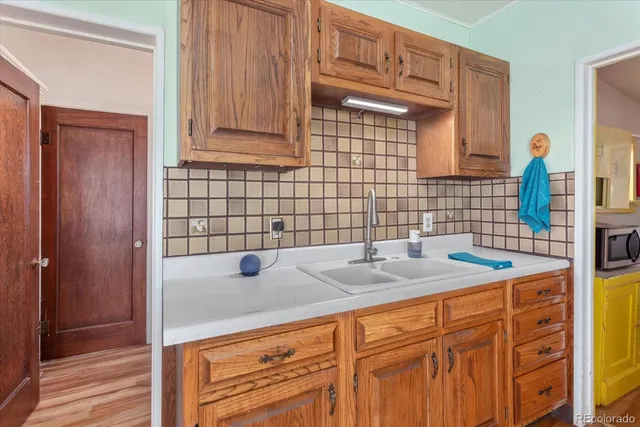 a kitchen with granite countertop cabinets and a stove top oven