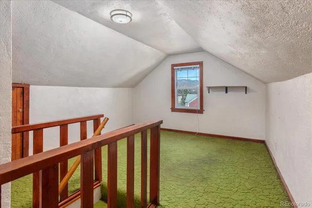 a view of a room with wooden floor and window