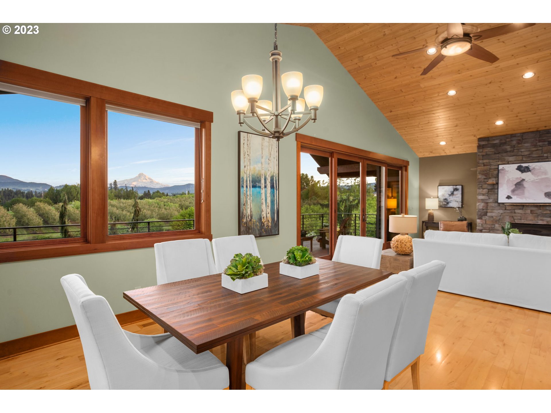 1575 Nunamaker Road Hood River, OR 97031 - Photo 14 of 48 a view of a dining room with furniture wooden floor and a chandelier