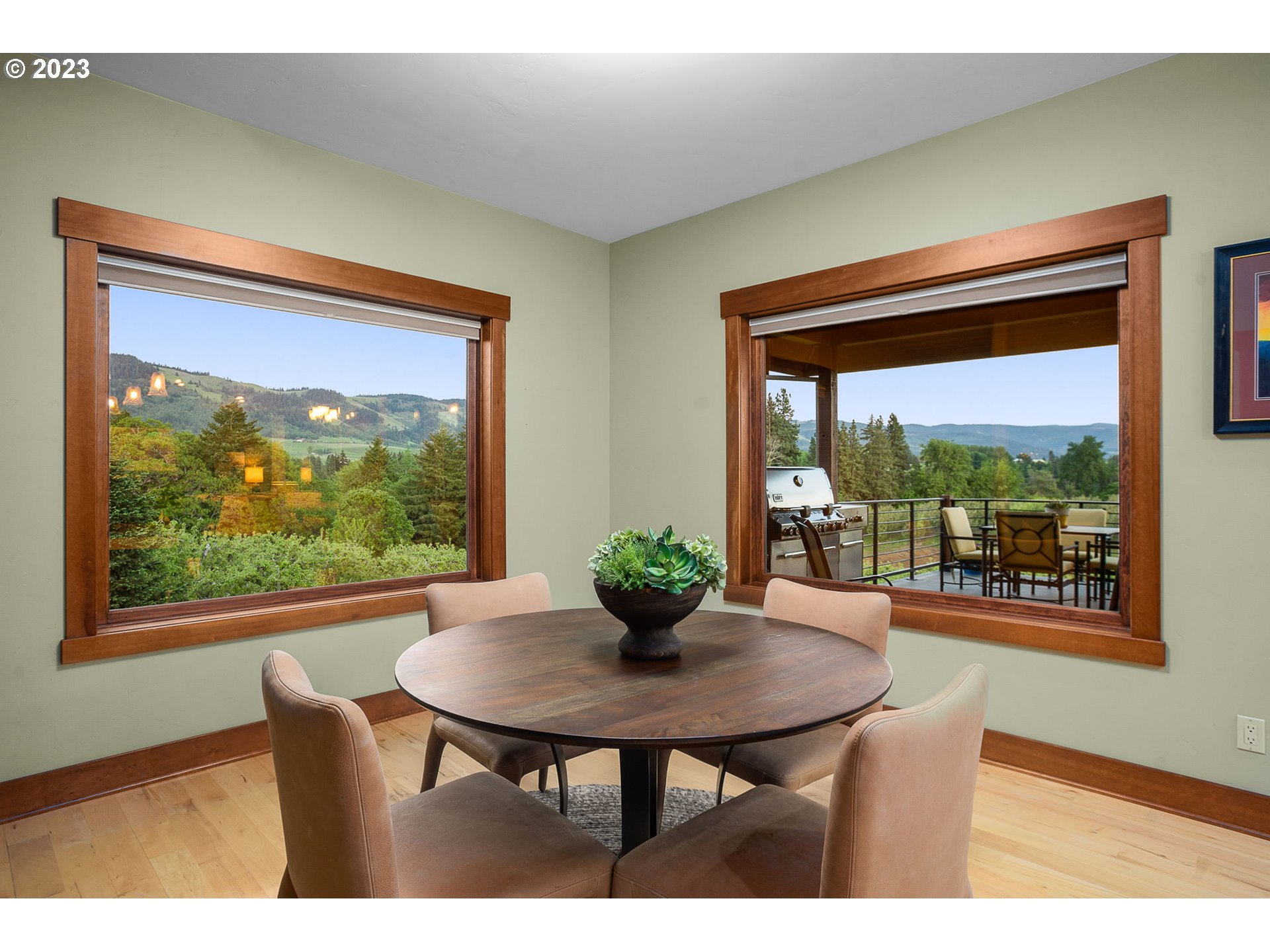 1575 Nunamaker Road Hood River, OR 97031 - Photo 16 of 48 a view of a dining room with furniture wooden floor and a potted plant