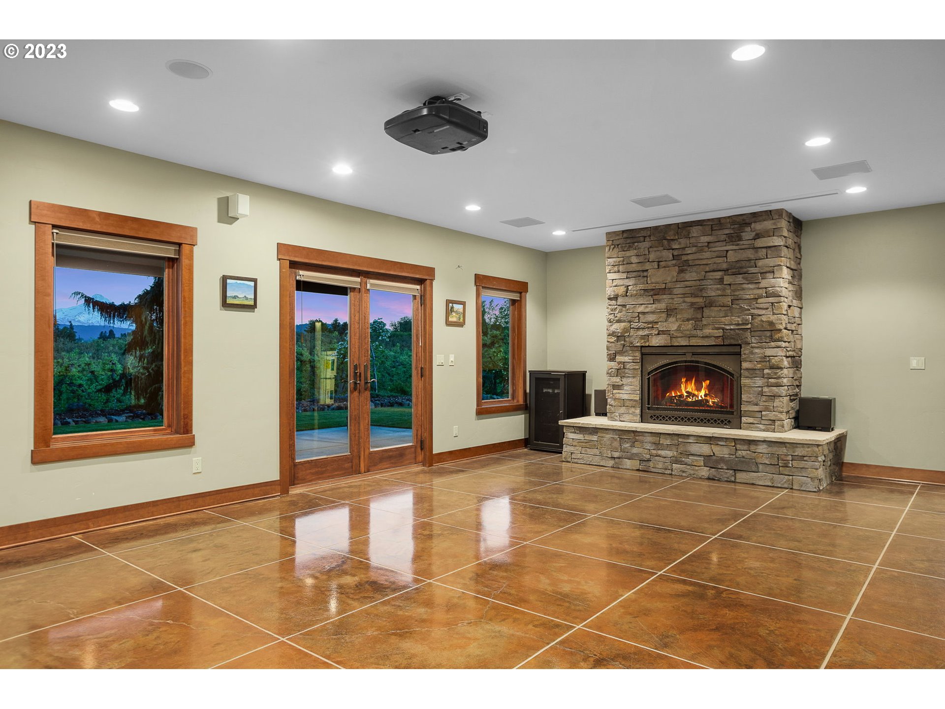 1575 Nunamaker Road Hood River, OR 97031 - Photo 23 of 48 a living room with furniture a fireplace and a flat screen tv