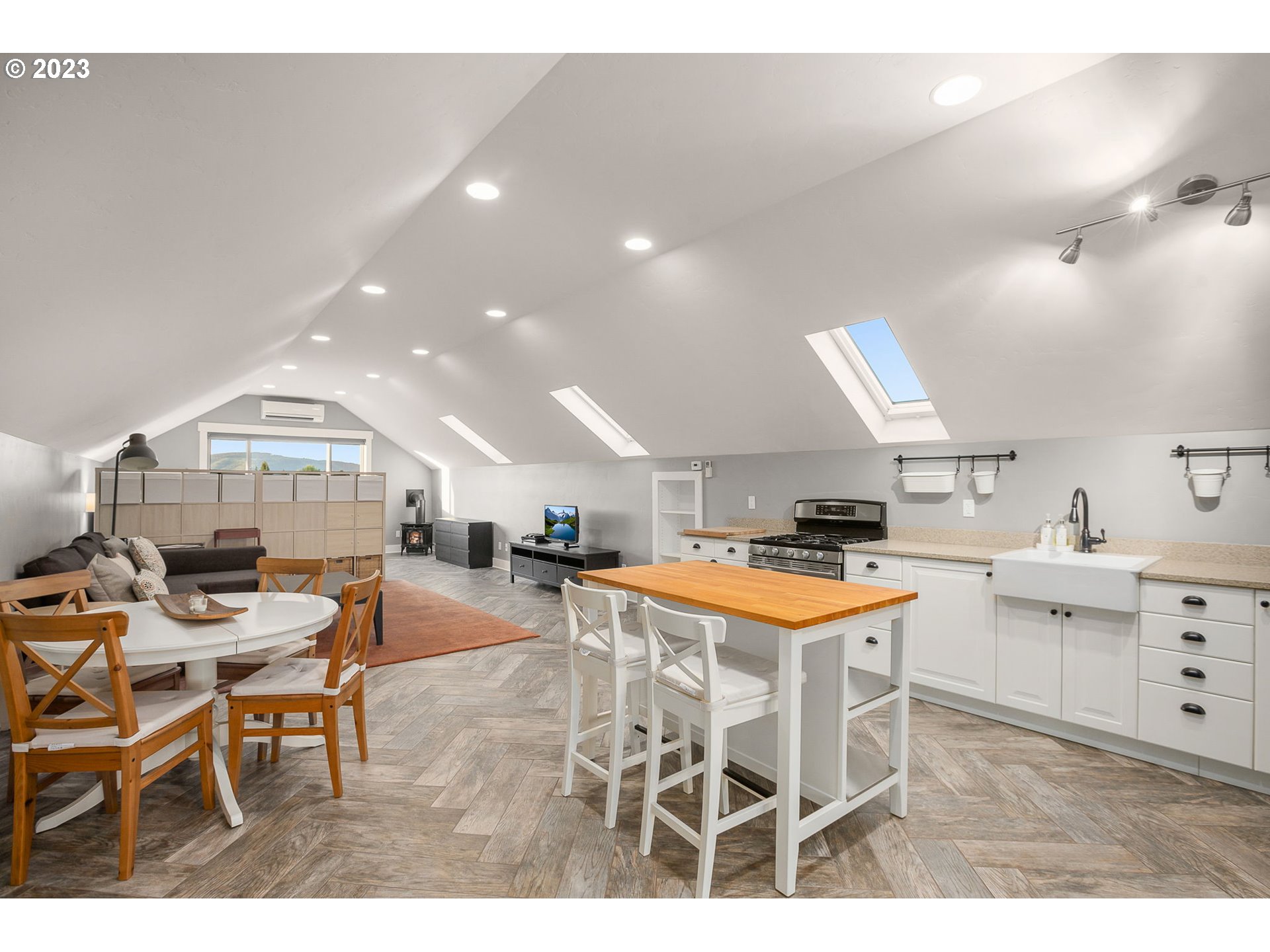 1575 Nunamaker Road Hood River, OR 97031 - Photo 29 of 48 a kitchen with stainless steel appliances kitchen island granite countertop a table chairs sink and cabinets