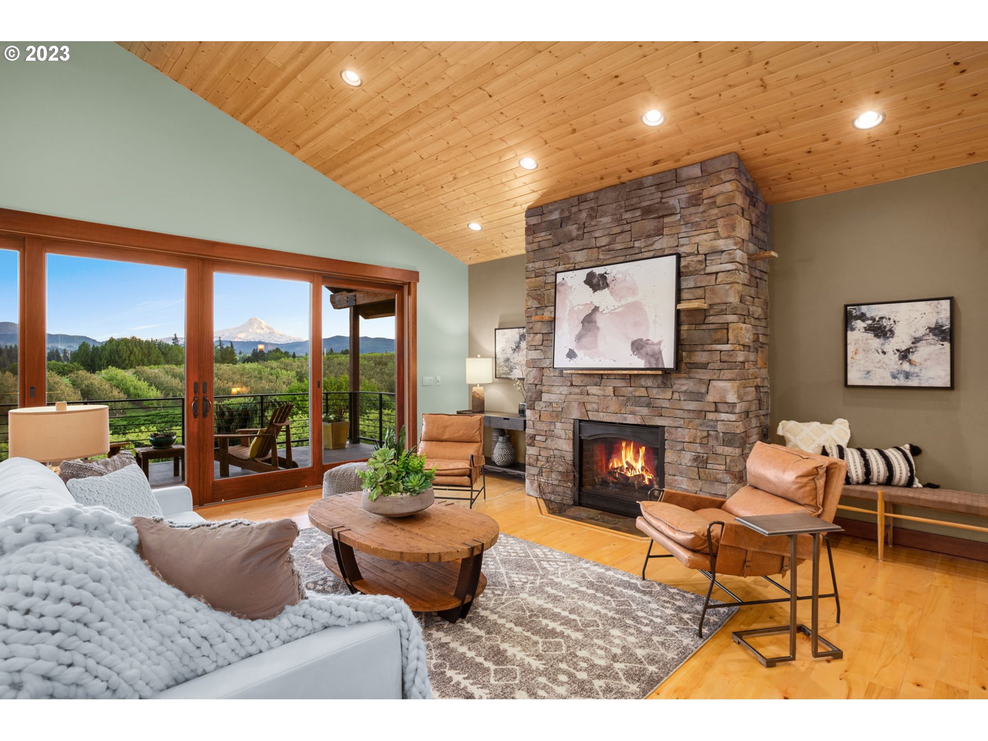 1575 Nunamaker Road Hood River, OR 97031 - Photo 5 of 48 a living room with furniture a fireplace and floor to ceiling windows
