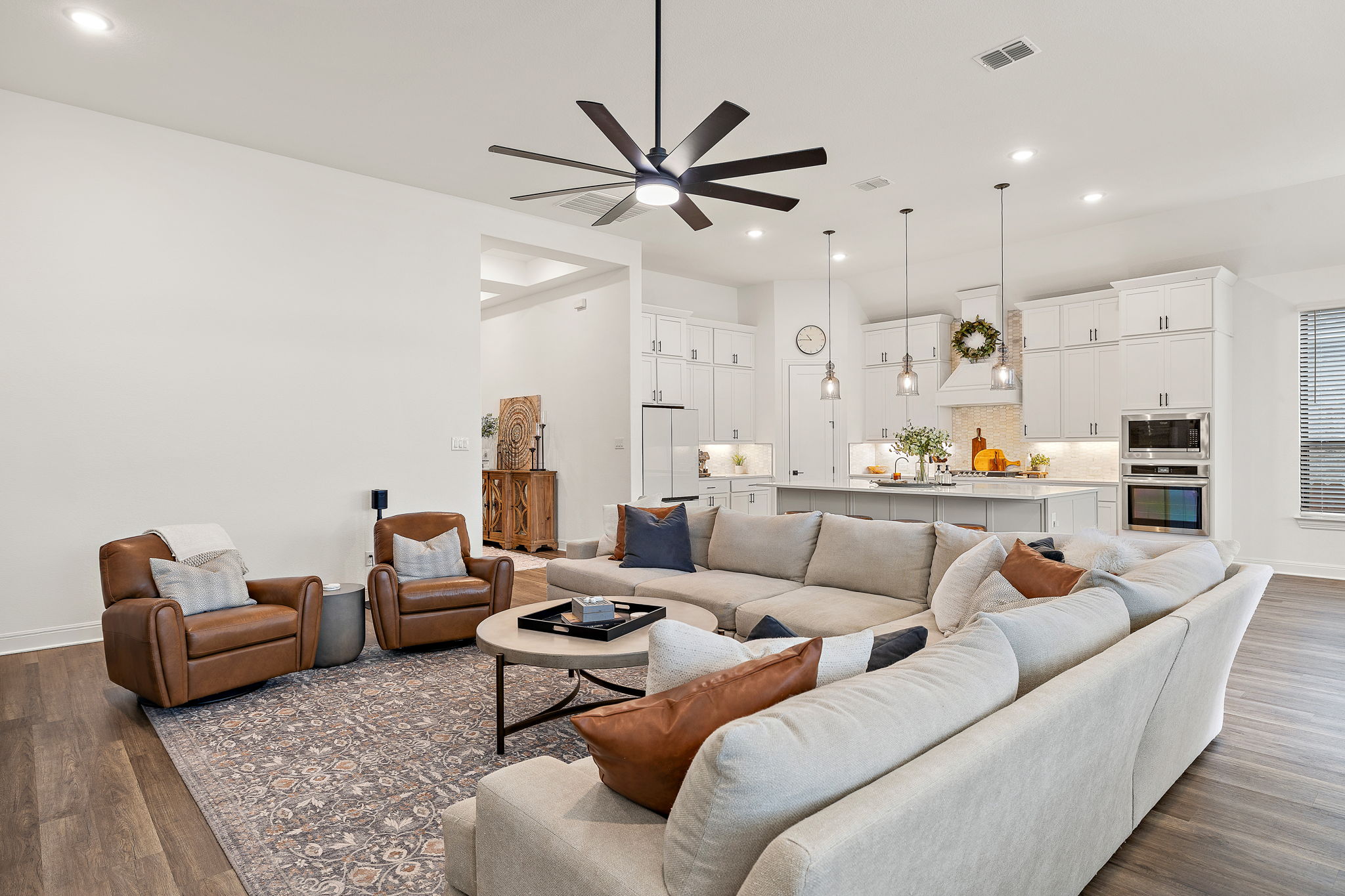 181 Constitution Way Kyle, TX 78640 - Photo 6 of 32 a living room with furniture kitchen view and a chandelier