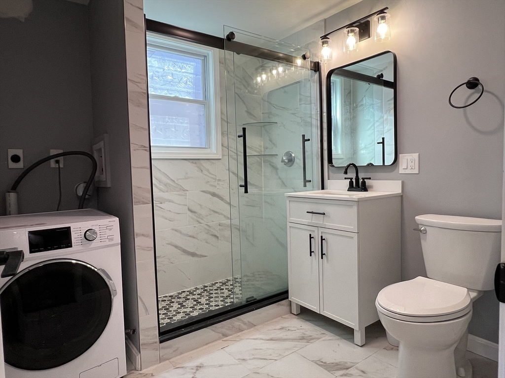 99 Chelsea Street, Unit 3 Boston, MA 02128 - Photo 7 of 10 a bathroom with a toilet sink and shower