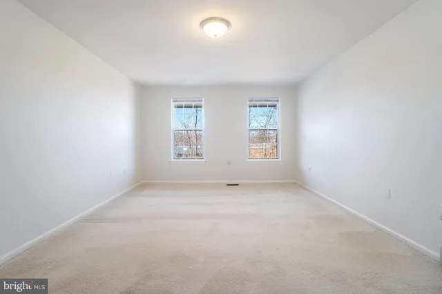 a view of an empty room and a window