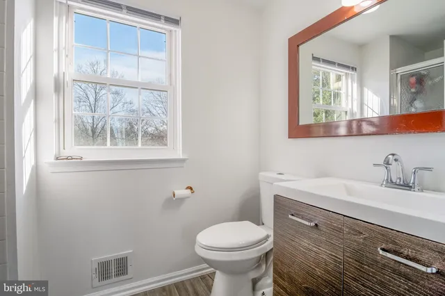 a bathroom that has a glass shower door