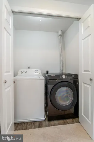 a view of empty room with wooden floor and floor to ceiling window