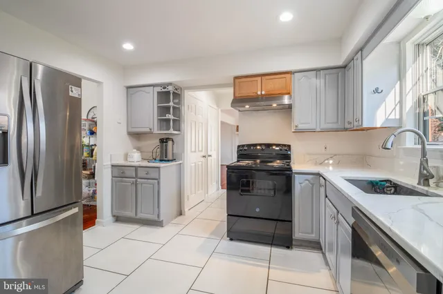 a kitchen with a refrigerator and a sink