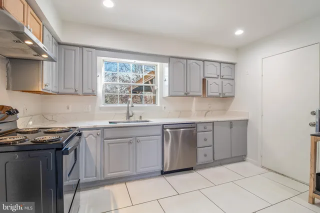 a dining room with furniture potted plants and wooden floor