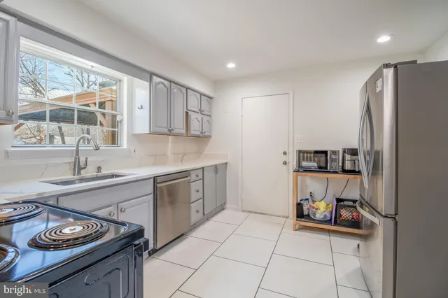 a view of a dining room with furniture a chandelier and wooden floor