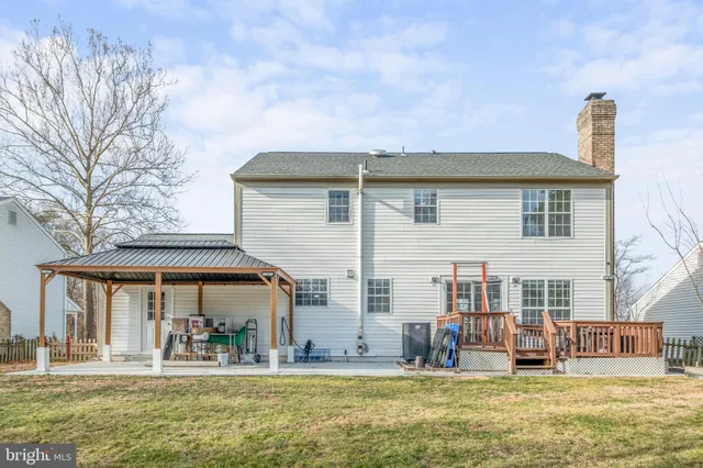 a house view with swimming pool and porch