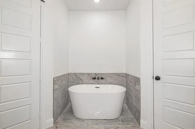 a bedroom with bed and wooden floor