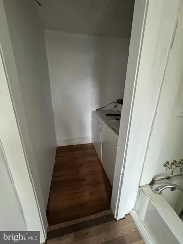 a view of a kitchen from a hallway