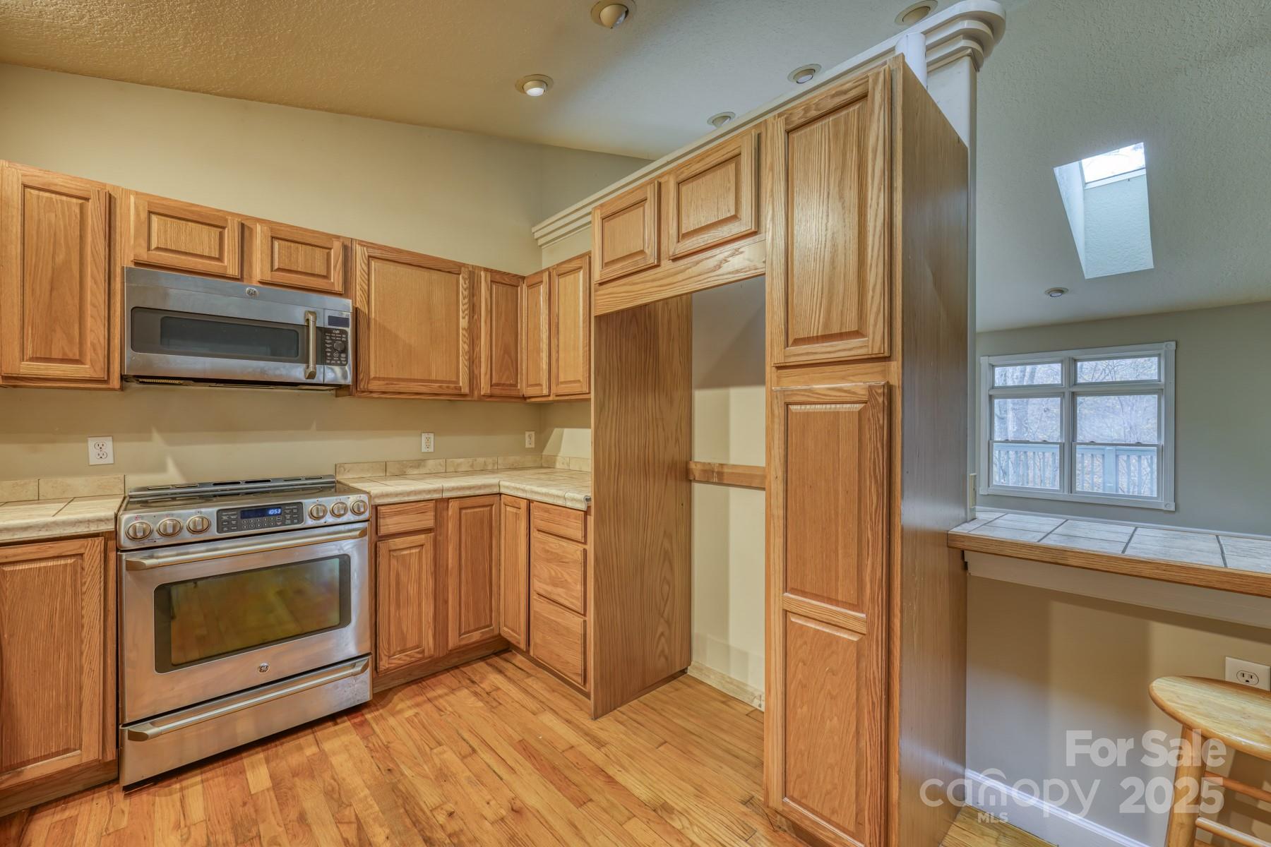 534 Parson Branch Road Green Mountain, NC 28740 - Photo 11 of 47 a kitchen with stainless steel appliances granite countertop a refrigerator stove and sink