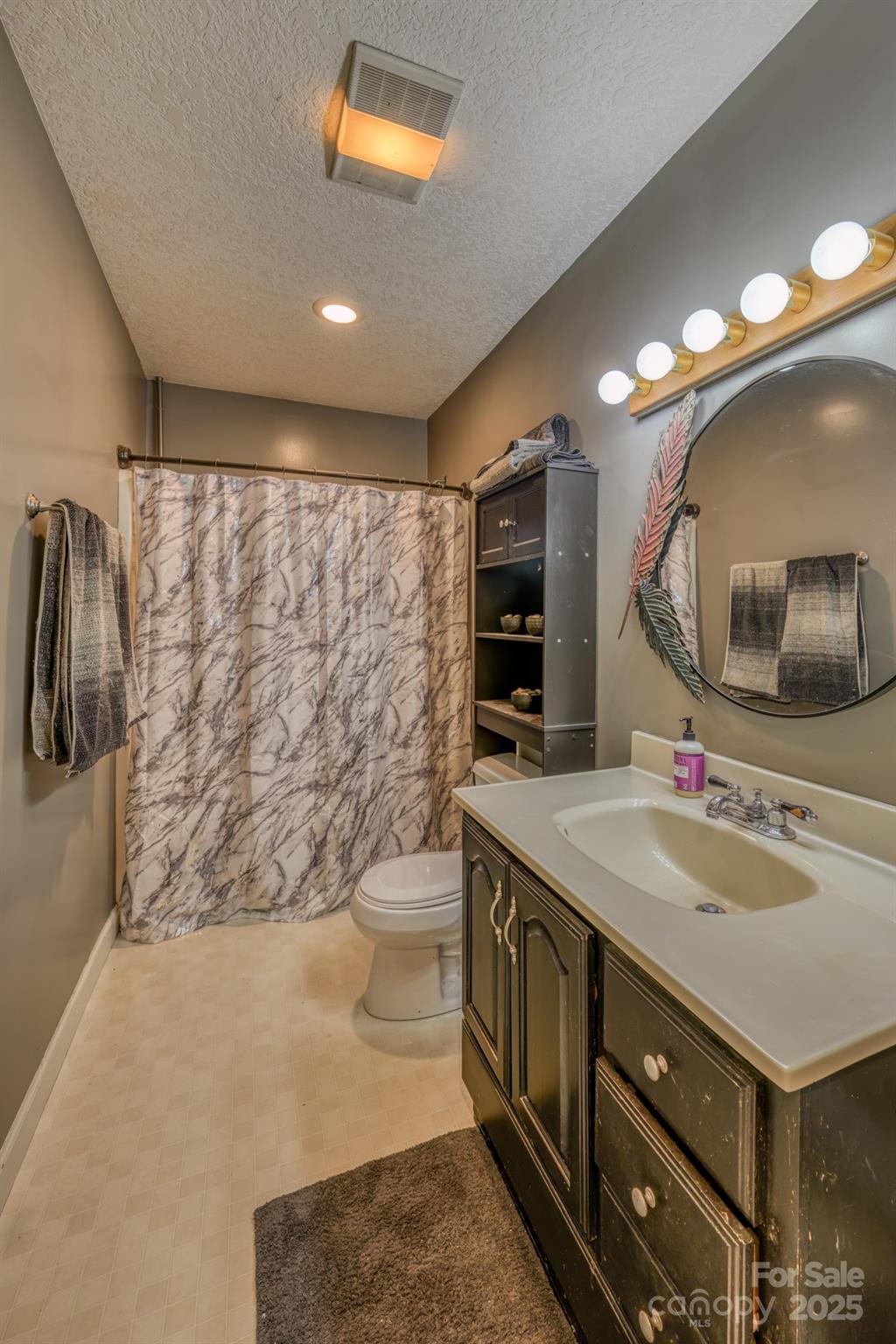 534 Parson Branch Road Green Mountain, NC 28740 - Photo 17 of 47 a bathroom with a double vanity sink mirror and shower
