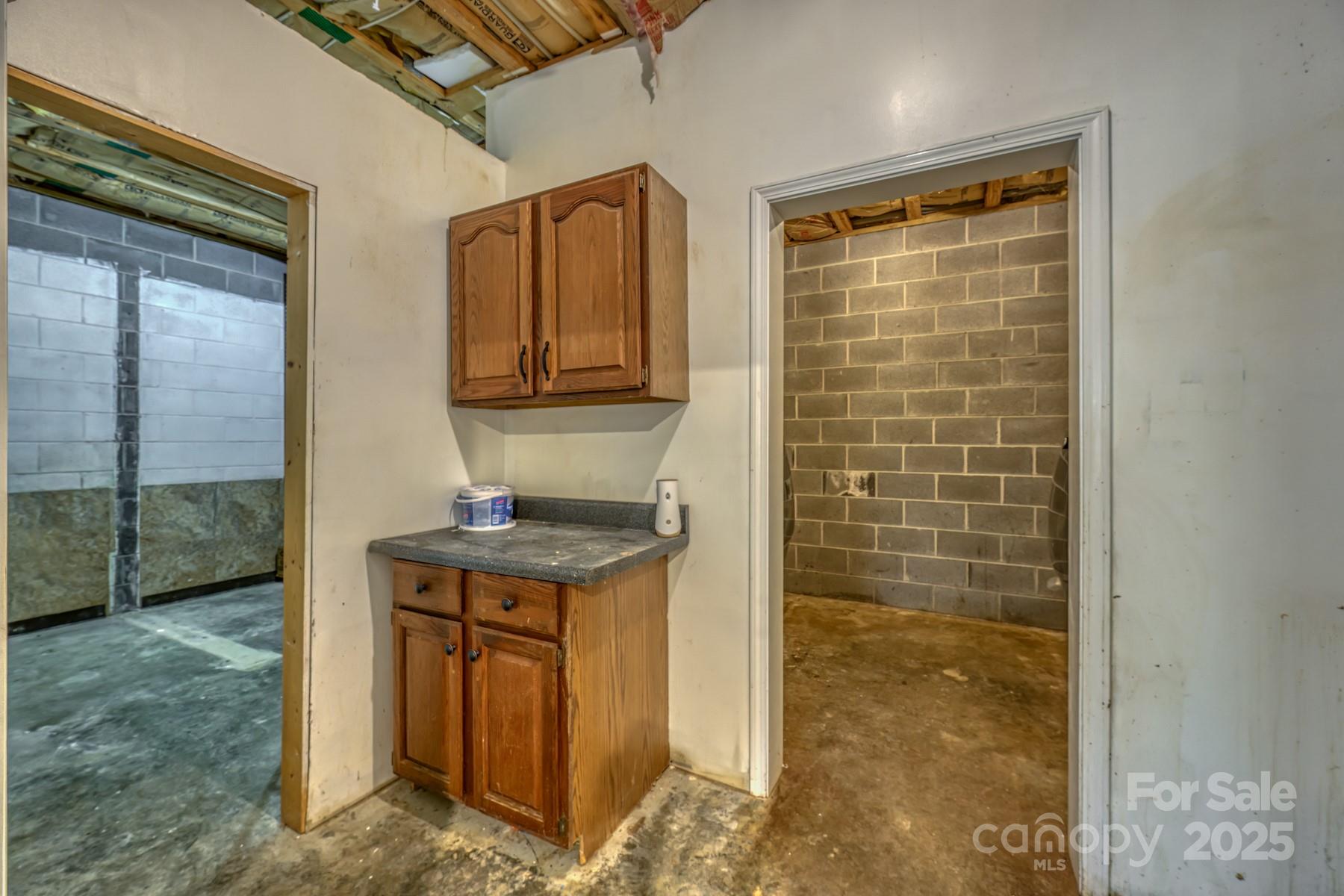 534 Parson Branch Road Green Mountain, NC 28740 - Photo 28 of 47 a bathroom with a granite countertop sink a mirror and shower
