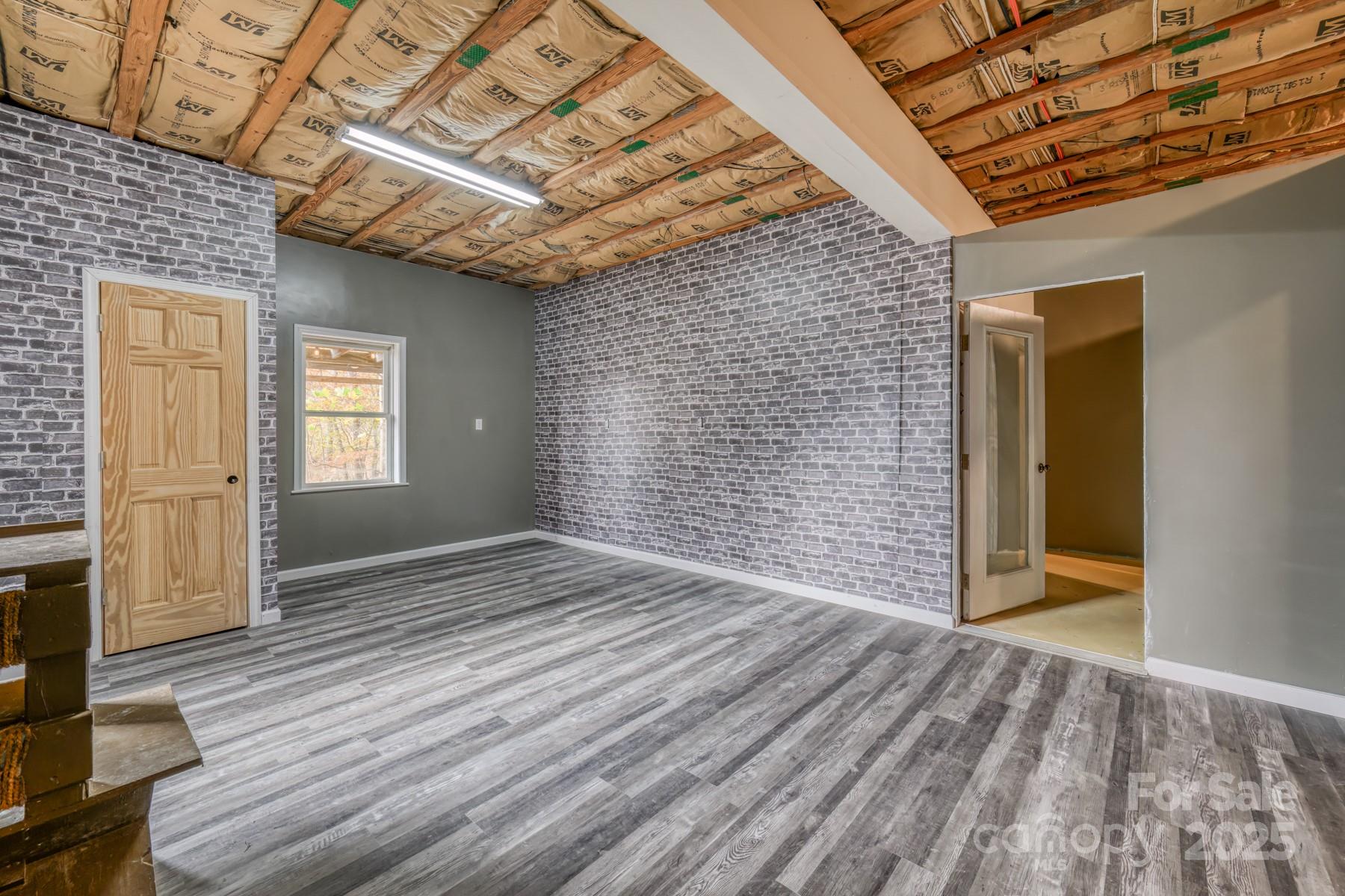 534 Parson Branch Road Green Mountain, NC 28740 - Photo 35 of 47 a view of an empty room with wooden floor and a window