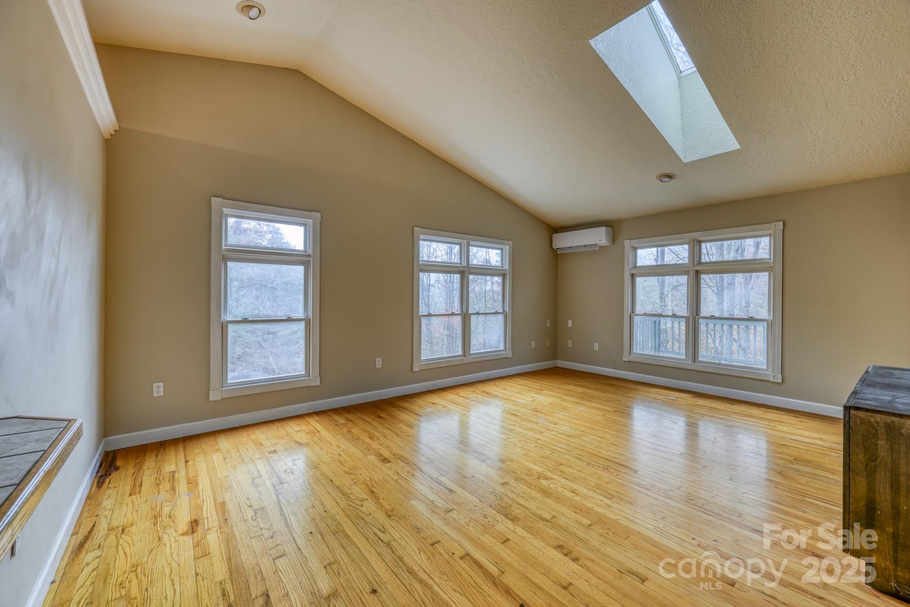 534 Parson Branch Road Green Mountain, NC 28740 - Photo 4 of 47 a view of an empty room with glass door and wooden floor