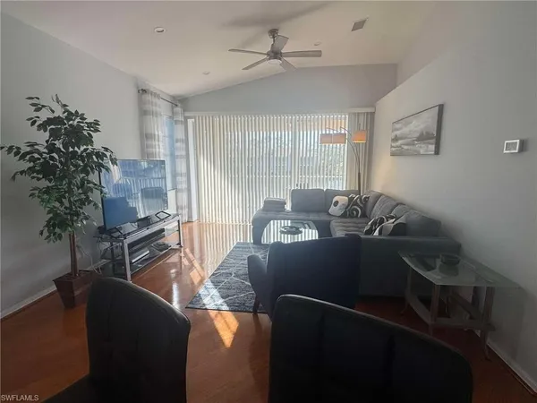 a living room with furniture rug and a window