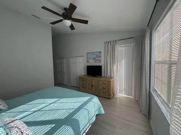 a bedroom with a bed closet and a window