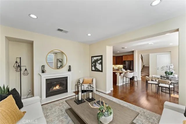 a living room with furniture a table and a fireplace