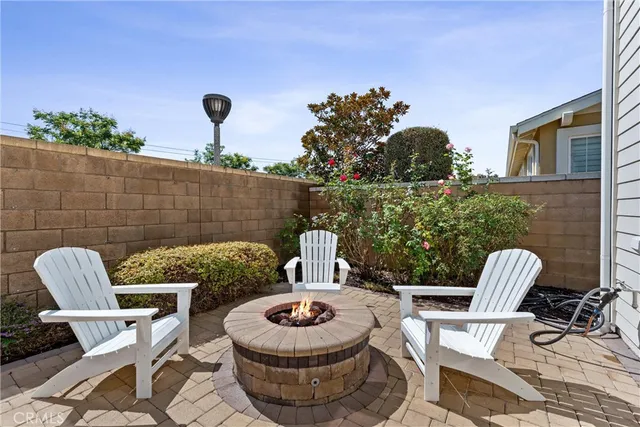 a view of a dinning table and chairs in the patio in front of a house