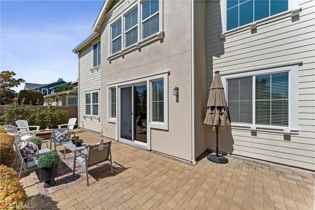 a view of a patio with couches chairs and potted plants