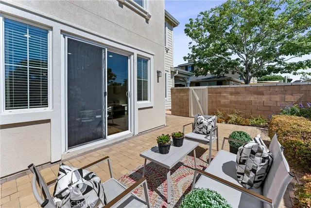 a view of a patio with couches chairs and potted plants