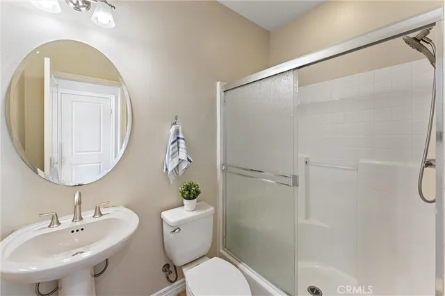 a living room with furniture potted plant and a flat screen tv