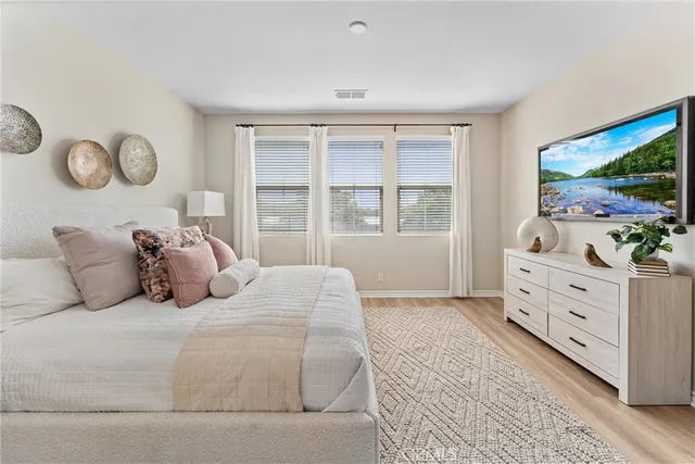 a bedroom with a bed and a television