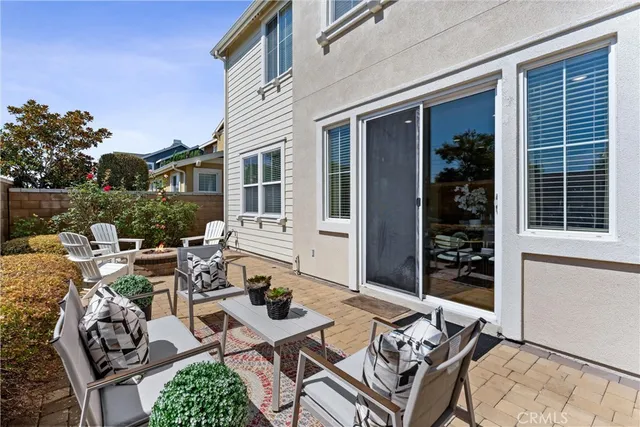 a view of a dinning table and chairs in patio of the house