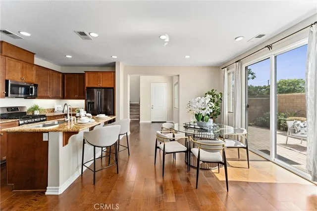 a view of a dining room with furniture window and wooden floor